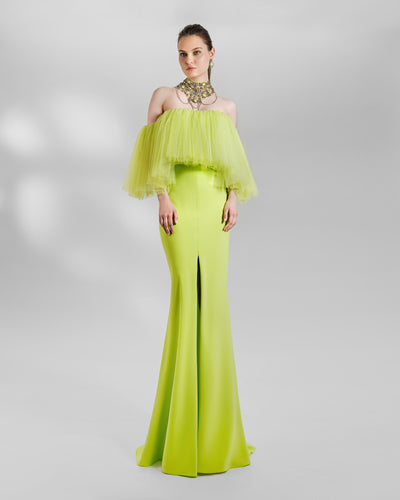 An evening look in lime color featuring an off-the-shoulders tulle top paired with a slim-cut skirt with a front slit. the look is completed with a matching beaded collar necklace.