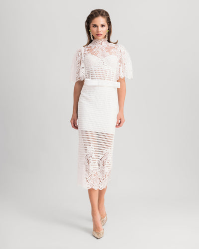 A white midi dress featuring a high-collar lace top with flared sleeves and a bow design at the waist, paired with a midi lace pencil skirt.