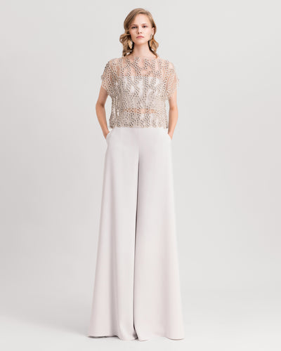A grey evening wear set featuring an embroidered tulle top paired with straight-cut pants.