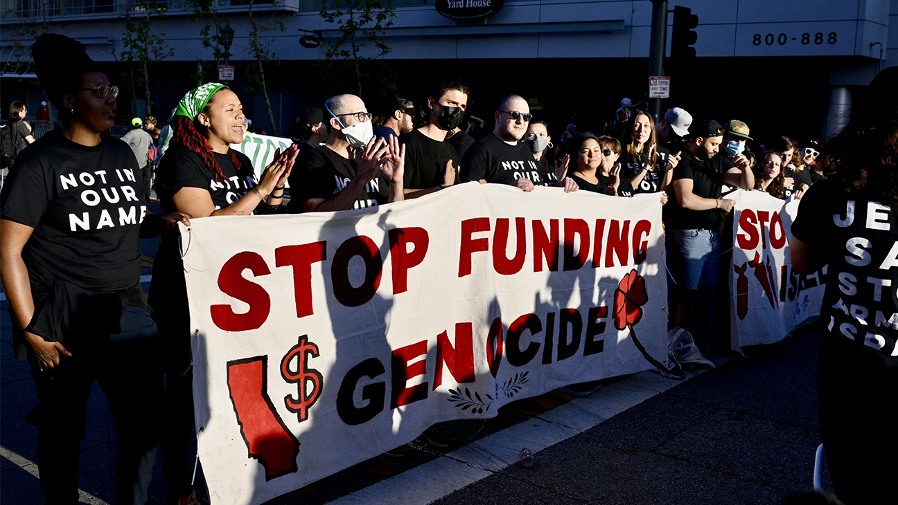 Pro-Palestine protesters occupy Olympic Boulevard in front of LA live as the President Biden fundraiser goes on inside Peacock Theater in Los Angeles.