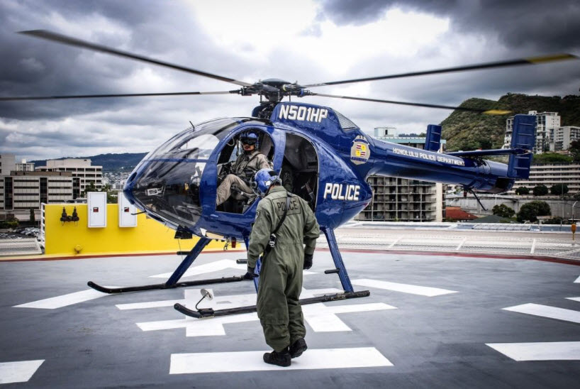 Specialized Services Division helicopter with two Specialized Services Division personnel