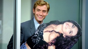 Jude Law carrying a cardboard cutout of a woman in 'I Heart Huckabees'