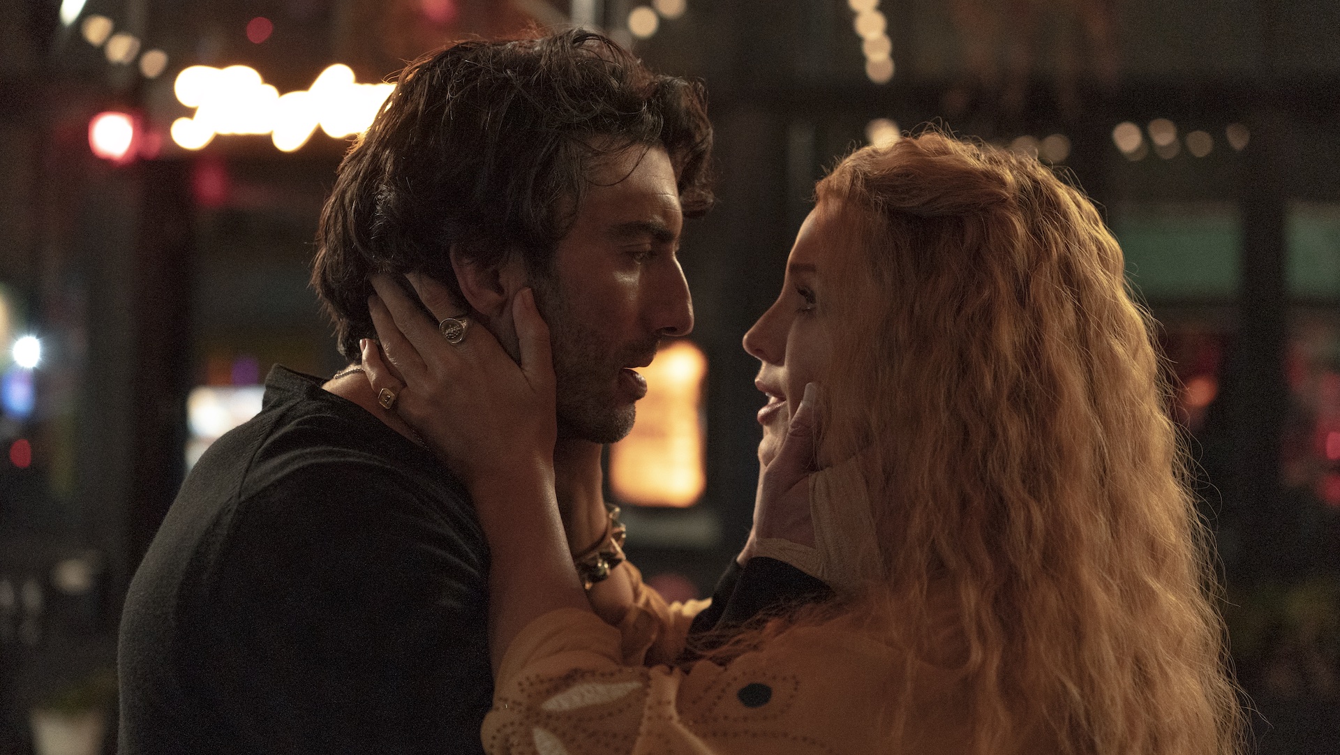 A woman holding a man's face as they look into each other's eyes; Blake Lively and Justin Baldoni in 'It Ends With Us'