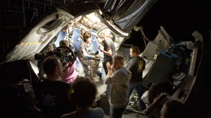 'GRAVITY,' Sandra Bullock (sitting, center), director Alfonso Cuarón (front, center), on set, 2013. ©Warner Bros. Pictures/courtesy Everett Collection