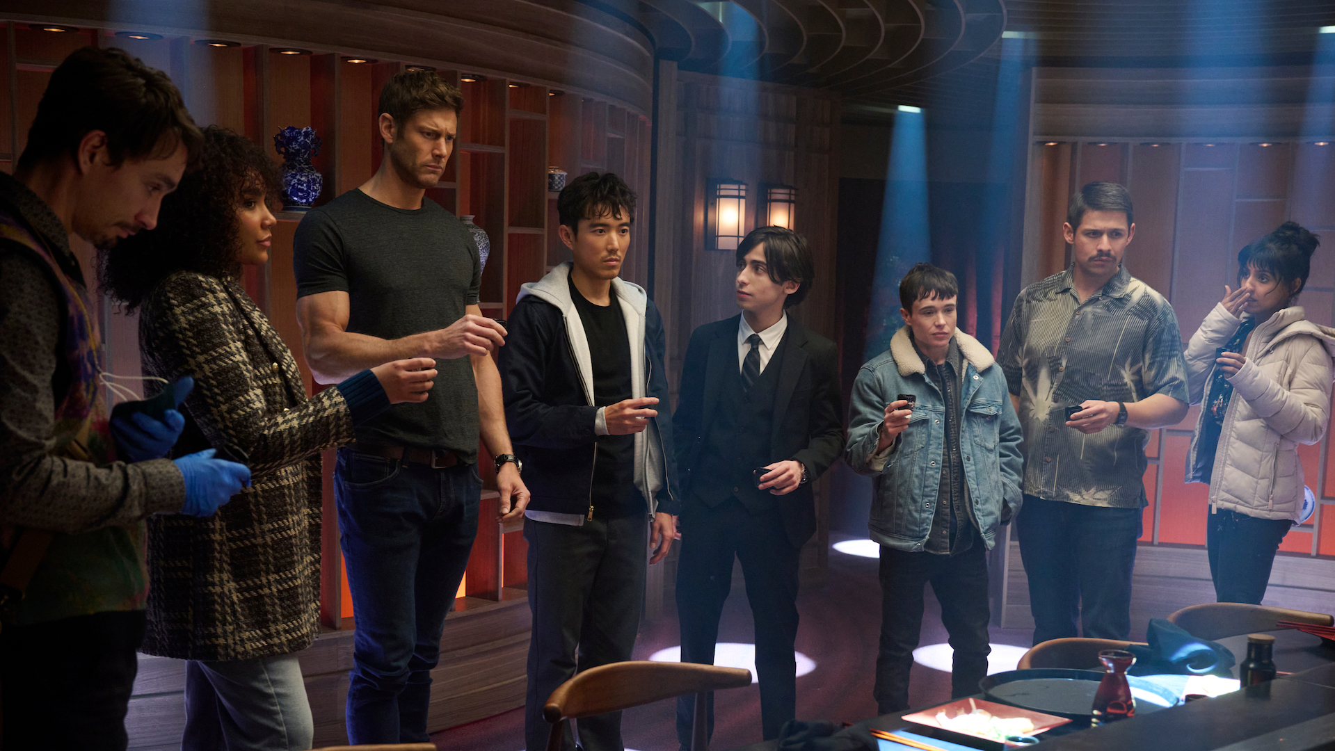 'The Umbrella Academy' (L to R) Robert Sheehan as Klaus Hargreeves, Emmy Raver-Lampman as Allison Hargreeves, Tom Hopper as Luther Hargreeves, Justin H. Min as Ben Hargreeves, Aidan Gallagher as Number Five, Elliot Page as Viktor Hargreeves, David Castañeda as Diego Hargreeves, Ritu Arya as Lila Pitts in episode 401 of The Umbrella Academy. Cr. Christos Kalohoridis/Netflix © 2024