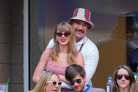 Travis Kelce Standing Behind Arms Around Taylor Swift Smiling Red Checkered Dress During U.S. Open Men's Singles Final Match September 8, 2024