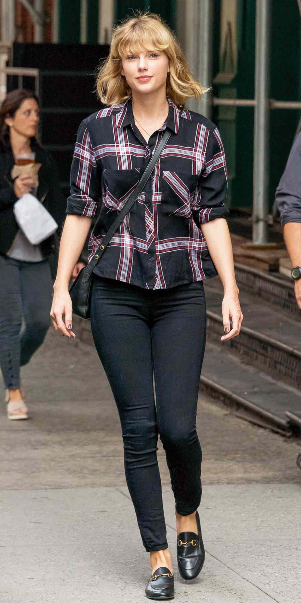 Taylor Swift in a plaid shirt, black skinny jeans, and Gucci loafers