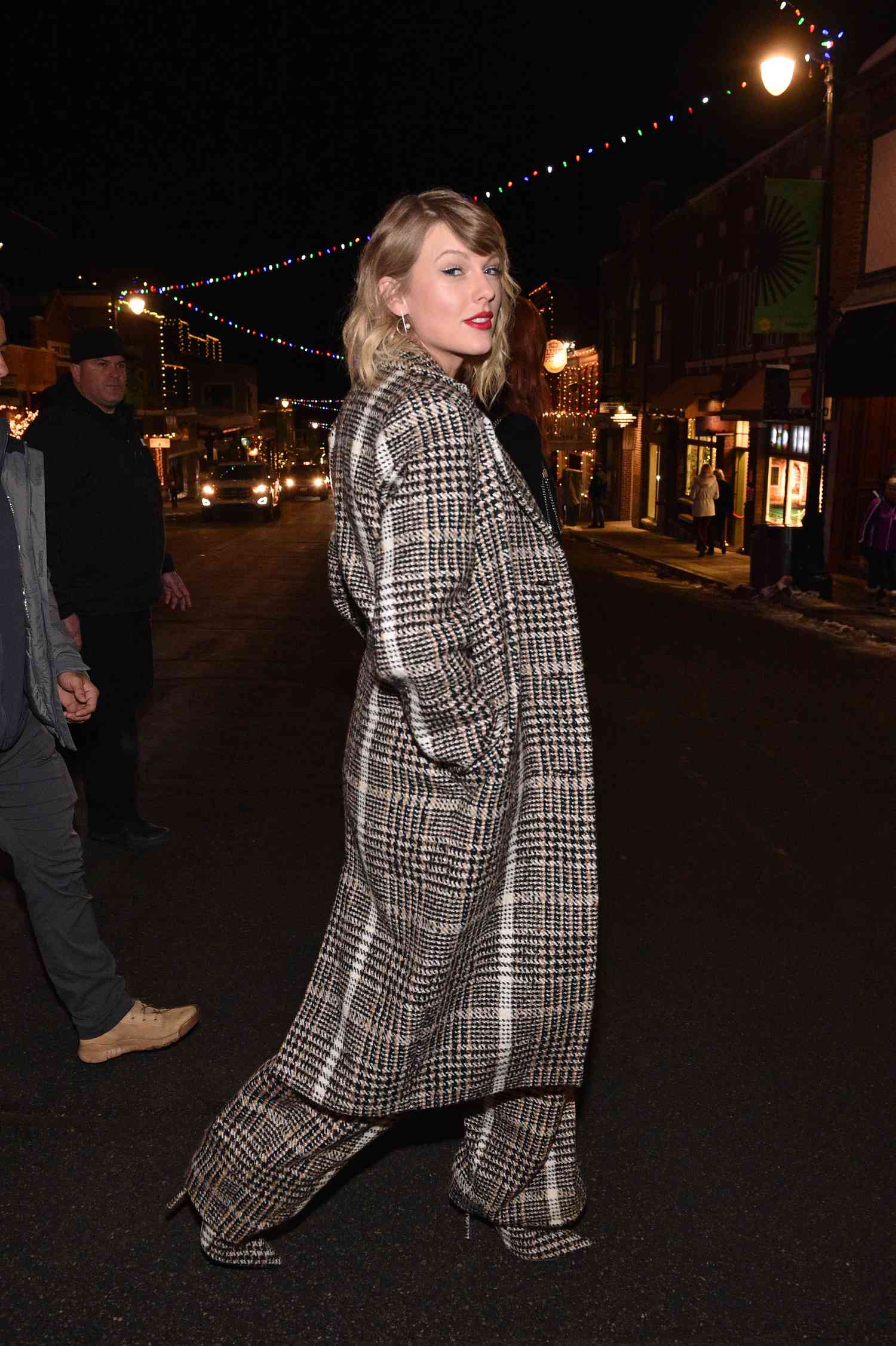 Taylor Swift in head-to-toe gray, black, and white plaid