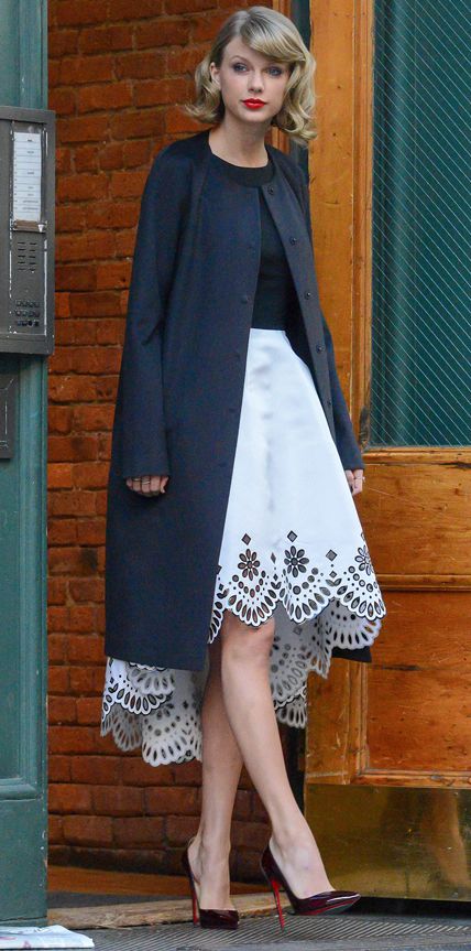 Taylor Swift in an Oscar de la Renta frock, Christian Louboutin heels, and a sleek black topper