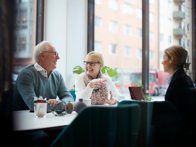 Older couple talking with a businesswoman
