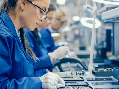 Workers in a factory assembling smartphones