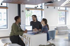 Three people in an office meeting