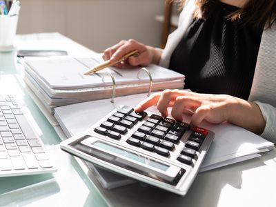 Accountant going over papers with a calculator