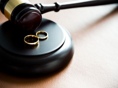 Illustration of divorce concept with two rings on gravel