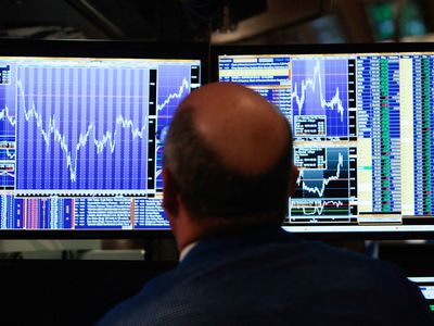 A financial professional loosk at his computer screen on the floor of the New York Stock Exchange at the end of the trading day