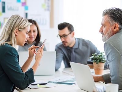 Business People Sitting Around the Desk in an Office, Having Meeting