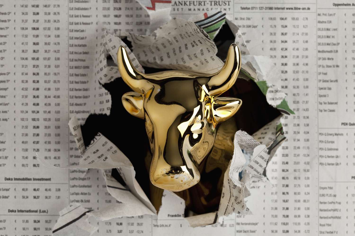 Detail of a Golden Bull Breaking Through the Finance Section of a Newspaper