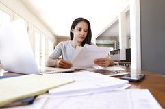 Woman doing paperwork at a table