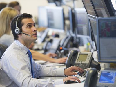 A man sitting at a stock trading desk