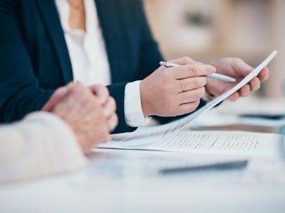 Person sitting and signing a contract