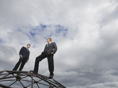 Two finance professionals stand on top of a geodesic dome.