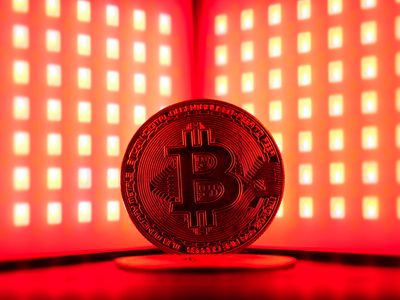 Symbolic photo of bitcoin in red light