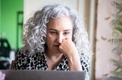 White woman studying laptop