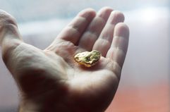 Hand Holding a Gold Nugget