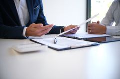 Cropped Image Of Insurance Agent Discussing With Client At Desk