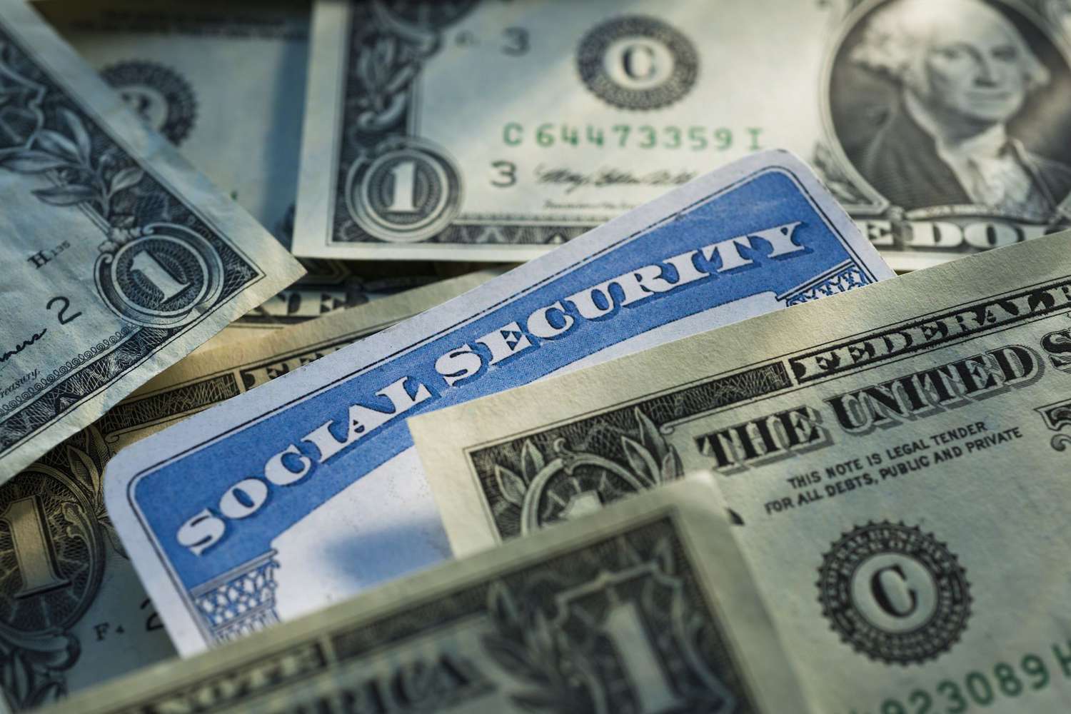 Social Security card surround by cash, representing tax on Social Security payments.