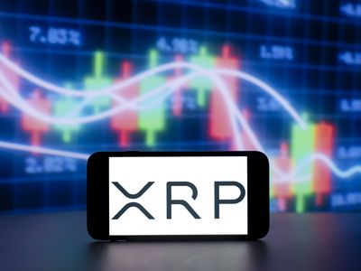 A photo illustration shows the XRP crypto coin logo on a cell phone screen, with stock market charts in the background.