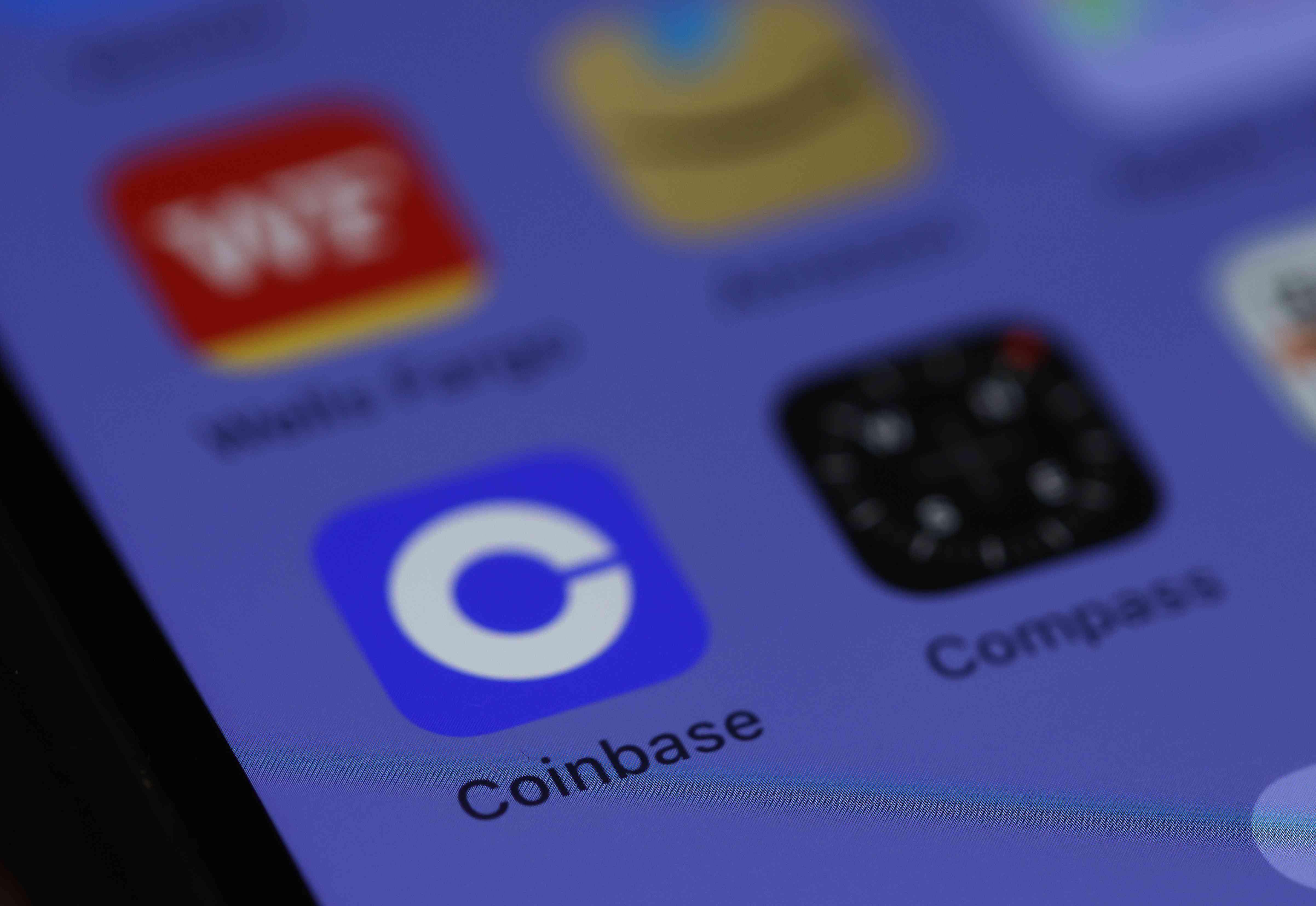 Coinbase logo is displayed on the screen of an iPhone on June 06, 2023 in San Anselmo, California.