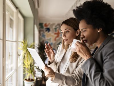 Two women looking at a mobile device