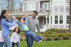 Hispanic family playing in front yard