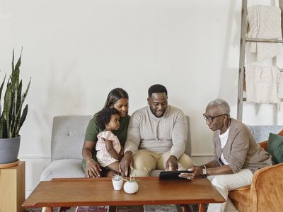 Financial advisor explaining paperwork to young couple with child