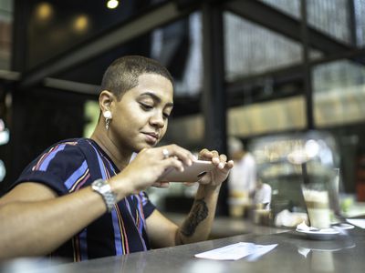 Person deposits check into bank account using a smartphone