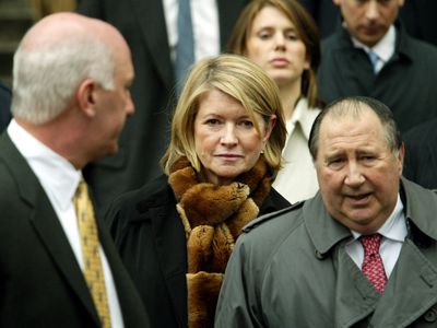 Martha Stewart, surrounded by a crowd of people, leaves a U.S. federal courthouse after being convicted on several charges.