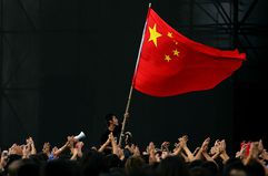A Chinese teenager waves a national flag during a festival to mark Chinese National Day in Beijing, China.