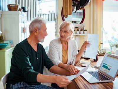 Elderly couple doing finances at home