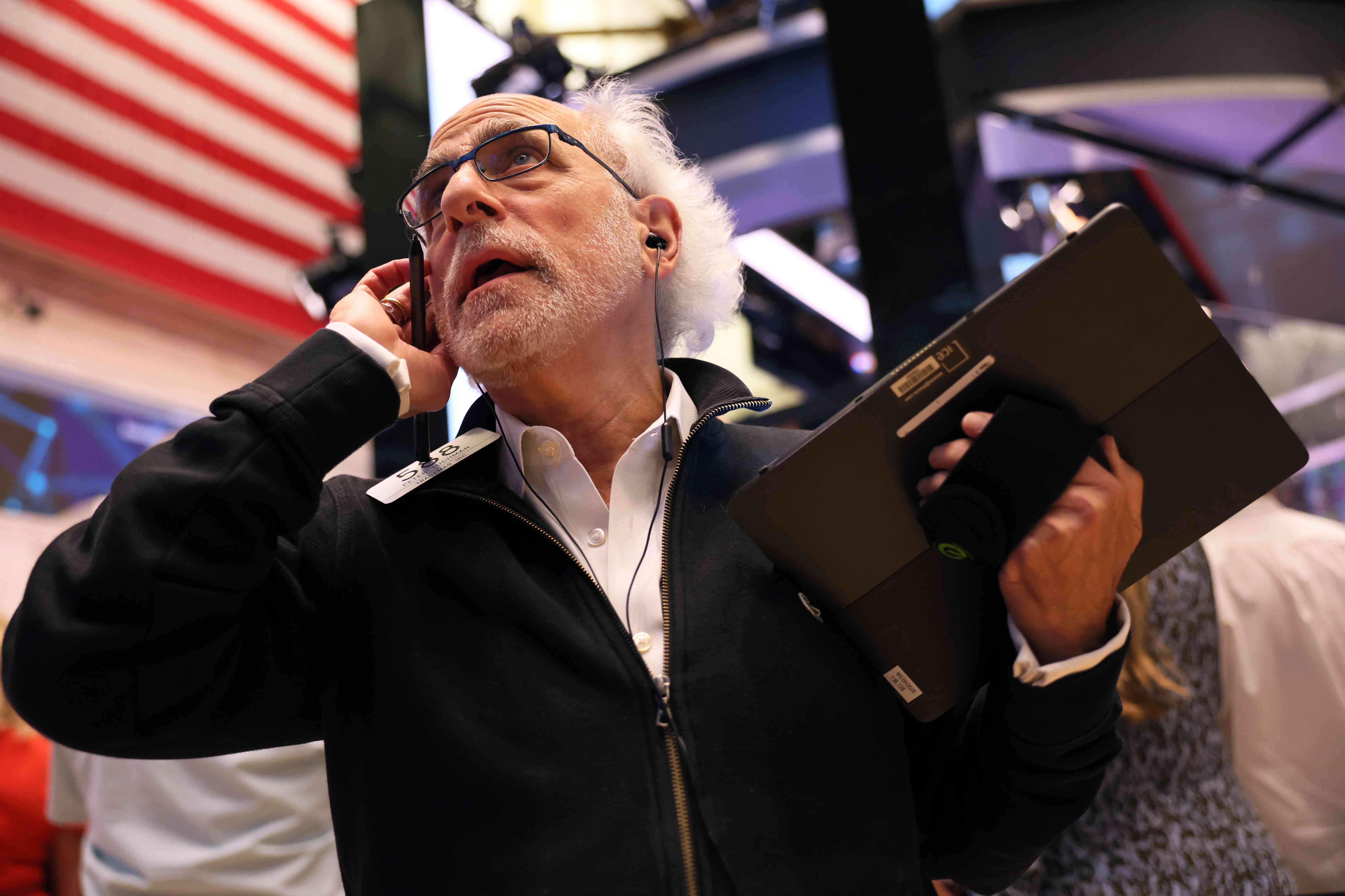 Stock trader Peter Tuchman works on the floor of the New York Stock Exchange.