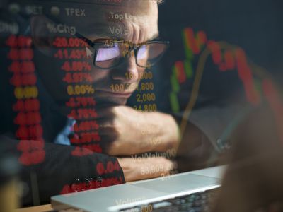 Businessman checking stock market data on computer screen and contemplating