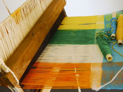 Vintage manual weaving loom with unfinished textile work