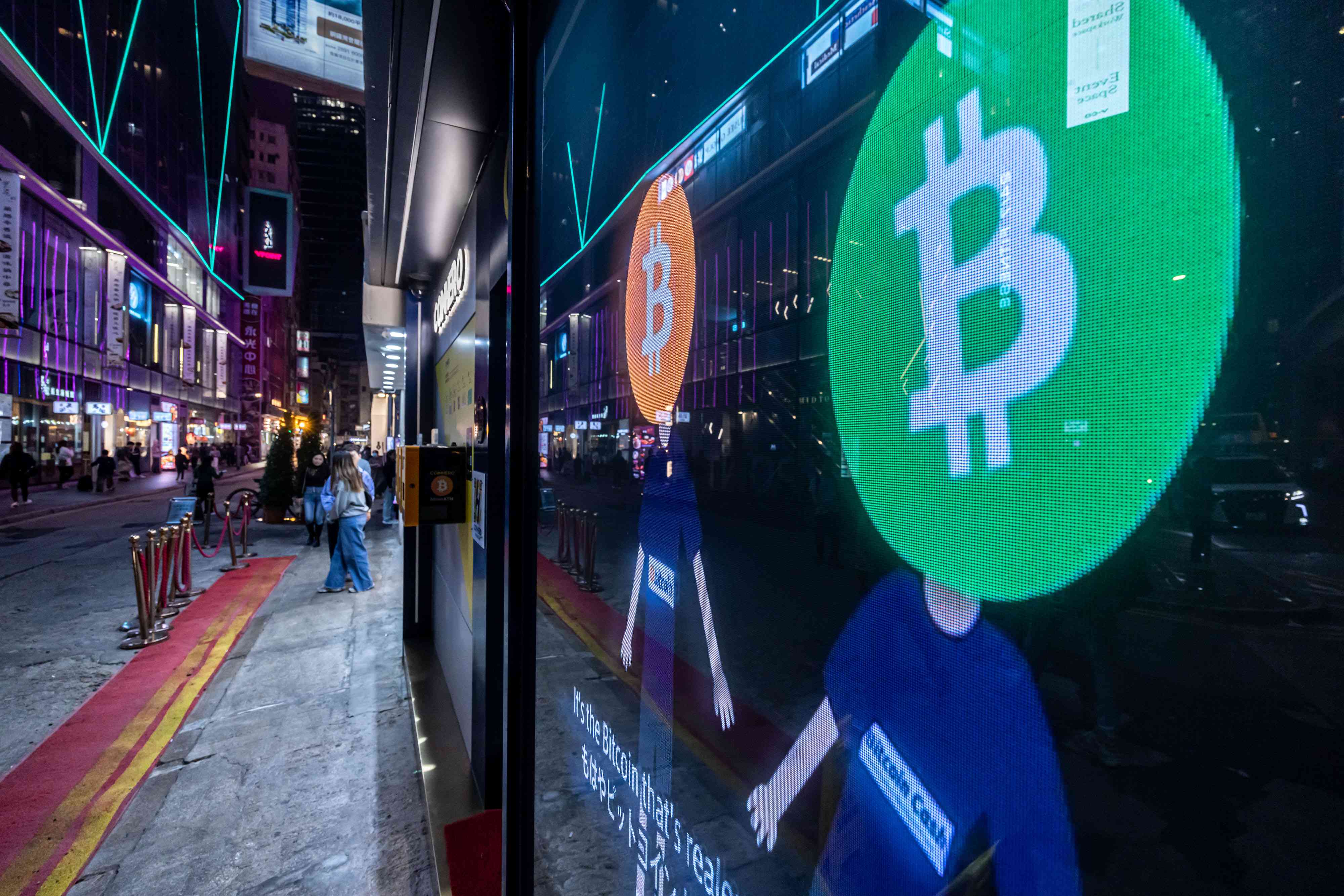 Bitcoin logos on a screen in Hong Kong, China, on Dec. 5, 2023.