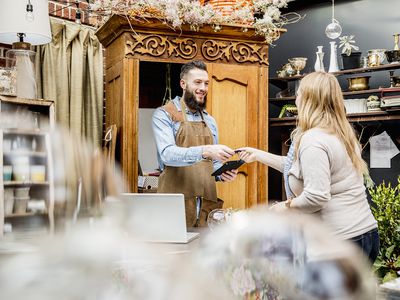 Employee Helping Customer Shopping in Store