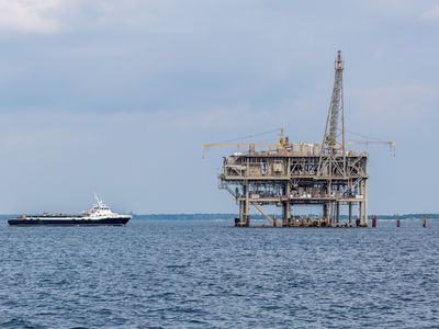 A ship approaches an Exxon Mobil oil rig in the Gulf of Mexico.