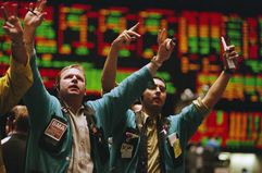 Traders signaling trades on a stock exchange floor