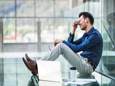 Frustrated Young Man with Laptop, Sitting on the Floor