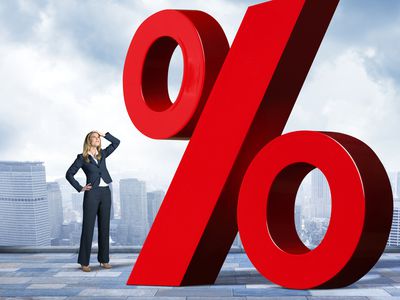 Businesswoman with hand on top of head is looking up at red percentage sign.