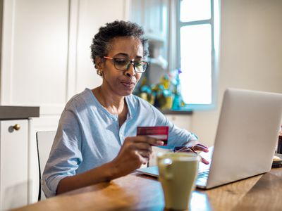 A woman shops online with a credit card.