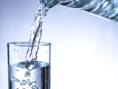 Pouring water from a pitcher into a glass